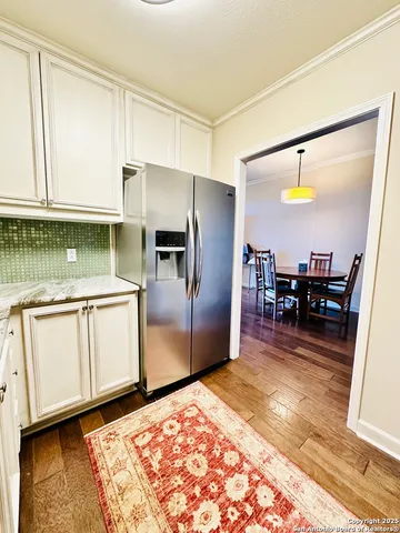 a kitchen with stainless steel appliances granite countertop a refrigerator and a stove