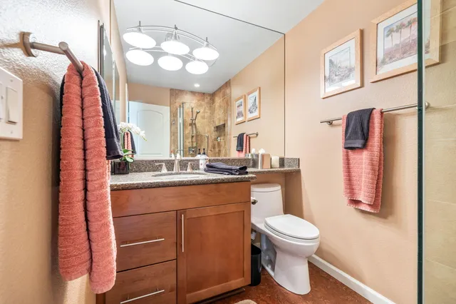 a bathroom with a sink a toilet and a mirror