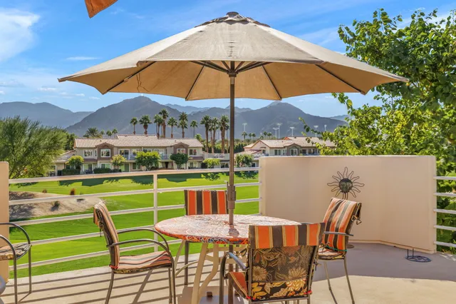 a view of a chairs and table in the backyard