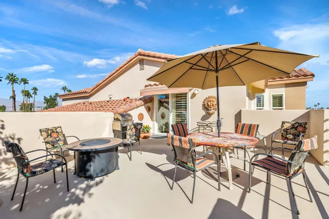 a view of a chairs and table in the patio
