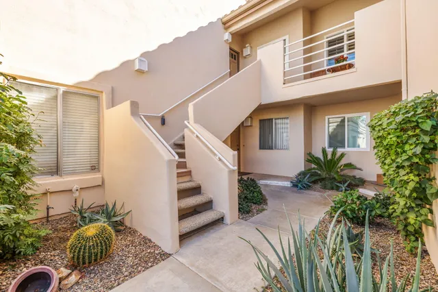a view of a house with wooden floor and a large tree
