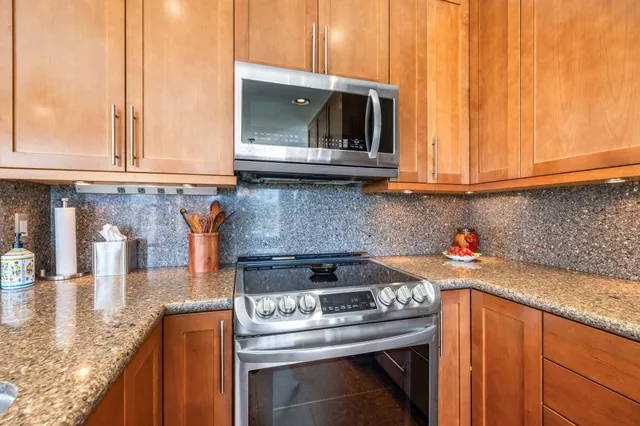 a kitchen with granite countertop a stove and a sink