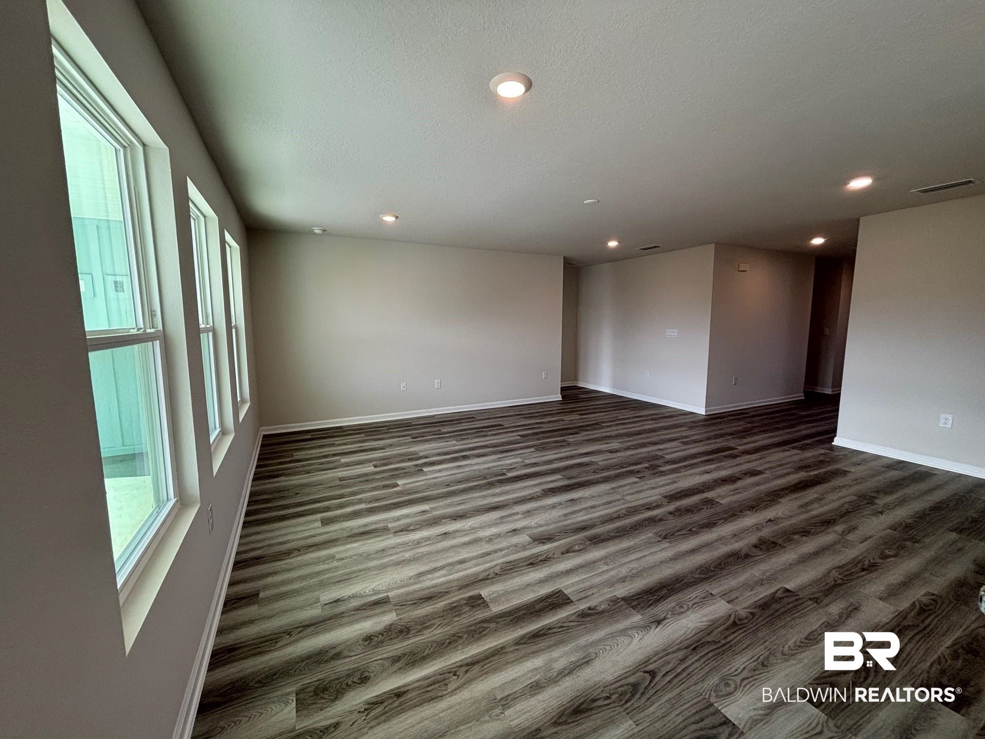 22044 Aleutian Avenue Foley, AL 36535 - Photo 9 of 28 Unfurnished room with a textured ceiling and dark hardwood / wood-style floors