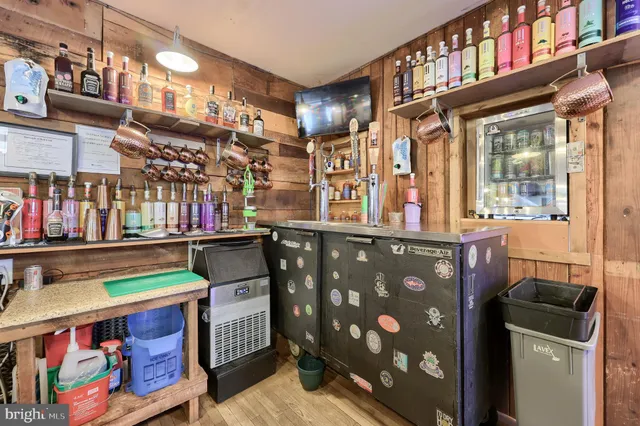 a living room with furniture a flat screen tv and kitchen view