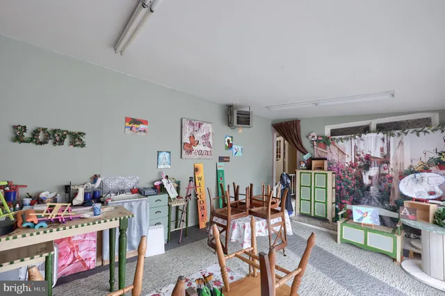 a room with stainless steel appliances living room dining room and wooden floor