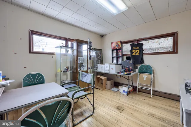 a view of a hall with wooden floor and couches