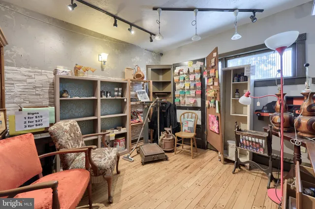 a view of a livingroom with furniture wooden floor and windows