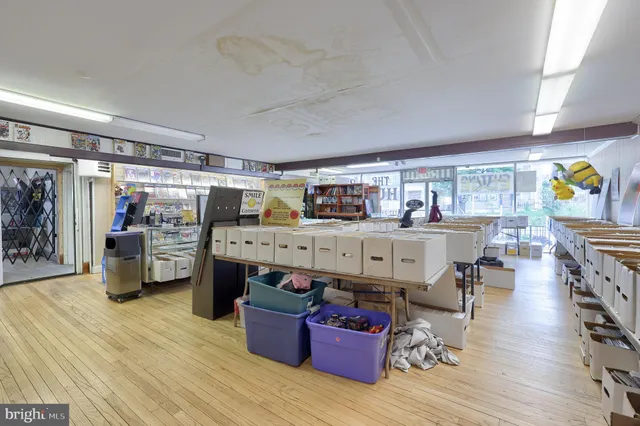 a view of empty room with wooden floor and window