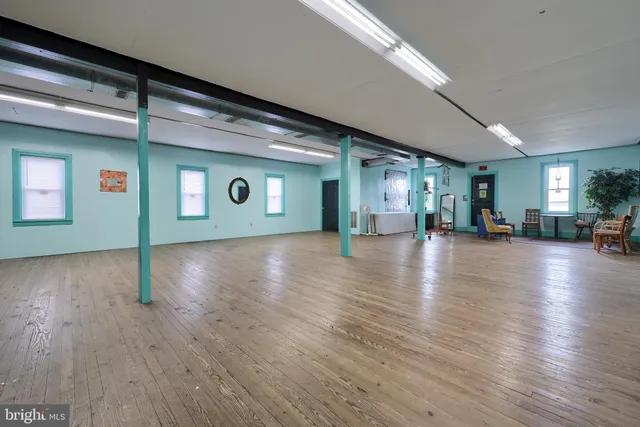 a view of a dining room with furniture and a chandelier