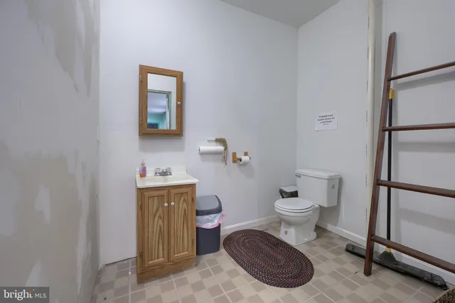 a room with furniture a rug and a book shelf