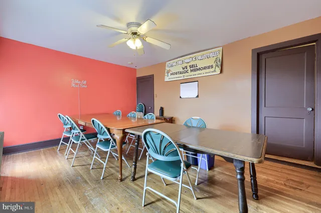 a living room with furniture a chandelier and a window