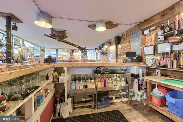 a kitchen with a table chairs and a wooden floor