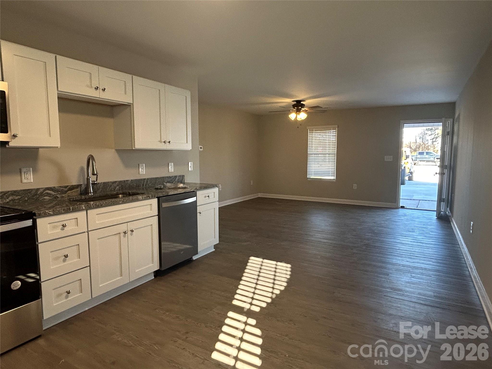 3303 Paul Elmore Road Lincolnton, NC 28092 - Photo 3 of 10 a kitchen with stainless steel appliances granite countertop a sink dishwasher a stove and a granite counter tops with wooden floors