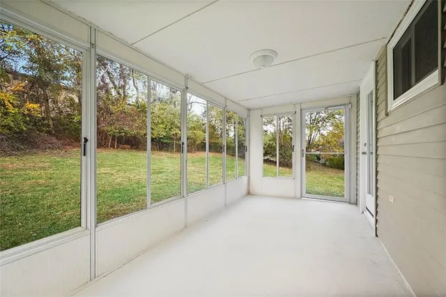 a view of an empty room with windows