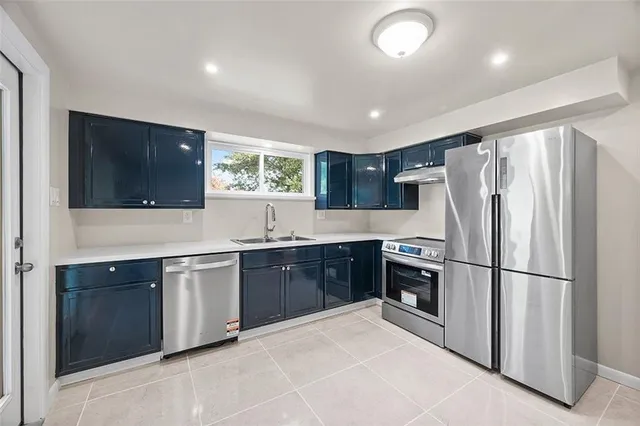 a kitchen with stainless steel appliances granite countertop a refrigerator sink and cabinets