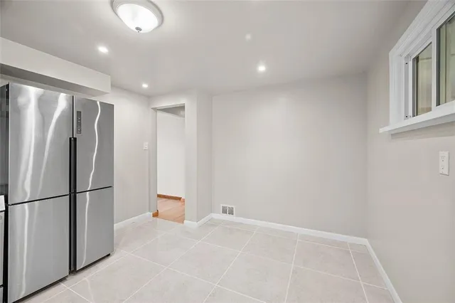 a view of an empty room with a fireplace