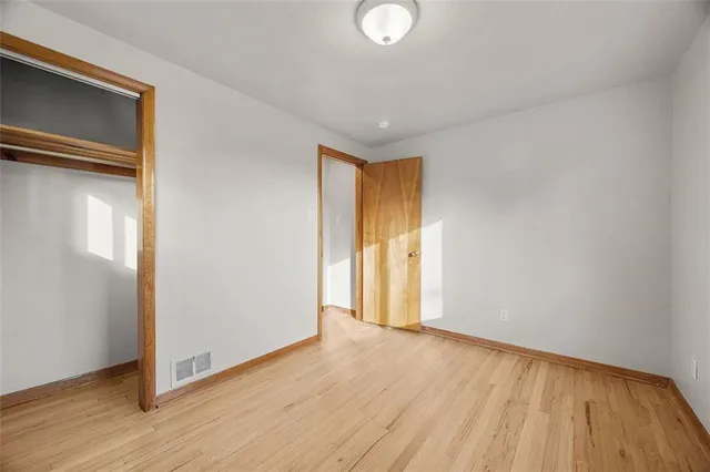 a view of an empty room and wooden floor