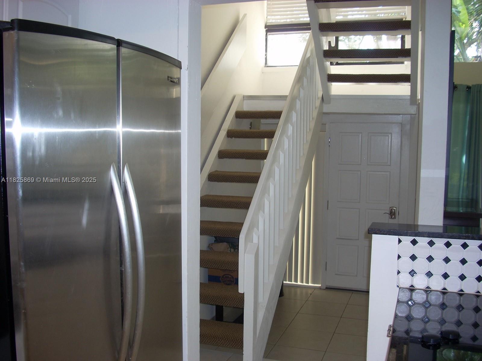Ojus Miami, FL 33180 - Photo 10 of 15 a view of staircase with white walls and railing