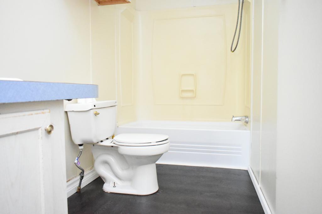 8607 Burleson Manor Road, Unit A Manor, TX 78653 - Photo 11 of 11 a white toilet sitting next to a bathroom sink
