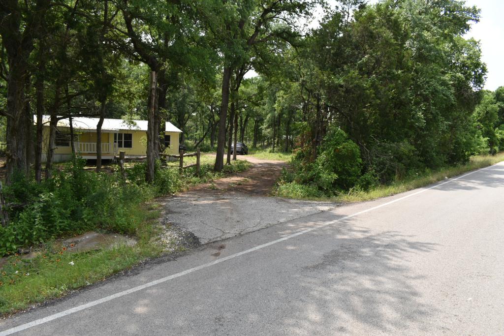 8607 Burleson Manor Road, Unit A Manor, TX 78653 - Photo 2 of 11 a view of a street with a trees