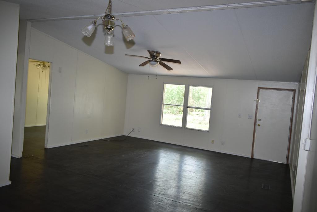 8607 Burleson Manor Road, Unit A Manor, TX 78653 - Photo 7 of 11 an empty room with wooden floor and windows