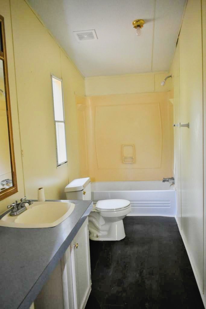 8607 Burleson Manor Road, Unit A Manor, TX 78653 - Photo 8 of 11 a bathroom with a sink a toilet and shower
