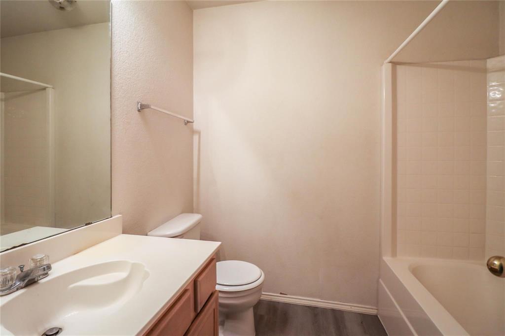 2004 Lennox Lane Arlington, TX 76018 - Photo 12 of 14 a bathroom with a sink and toilet