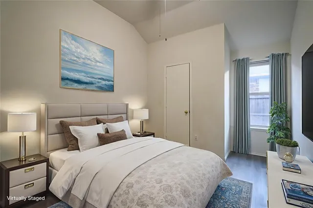 a bedroom with bed and wooden floor