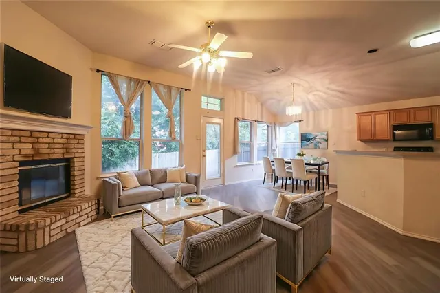 a living room with fireplace furniture and a flat screen tv