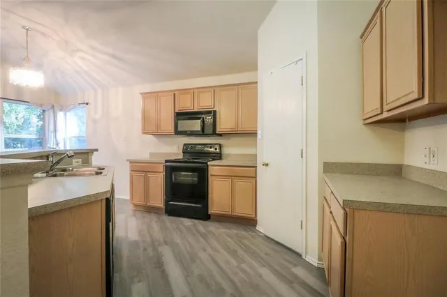 a kitchen with a sink stove and refrigerator
