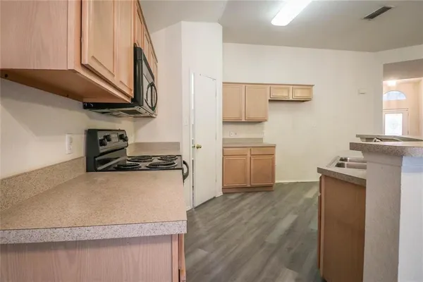 a kitchen with a stove and a microwave