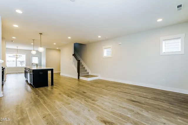 a view of kitchen and hall with wooden floor