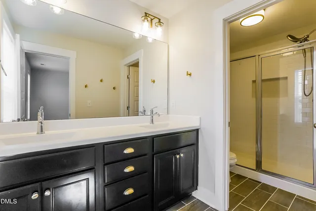 a bathroom with a double vanity sink and mirror