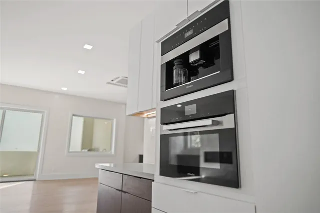 a bathroom with a white tub shower and sink