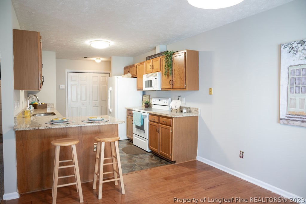 5804 Bibar Road Fayetteville, NC 28304 - Photo 11 of 37 a kitchen with a sink cabinets and window
