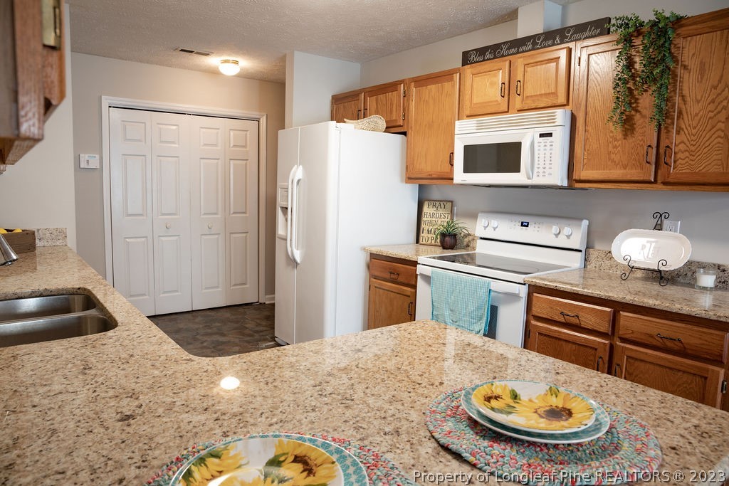 5804 Bibar Road Fayetteville, NC 28304 - Photo 12 of 37 a kitchen with refrigerator and window