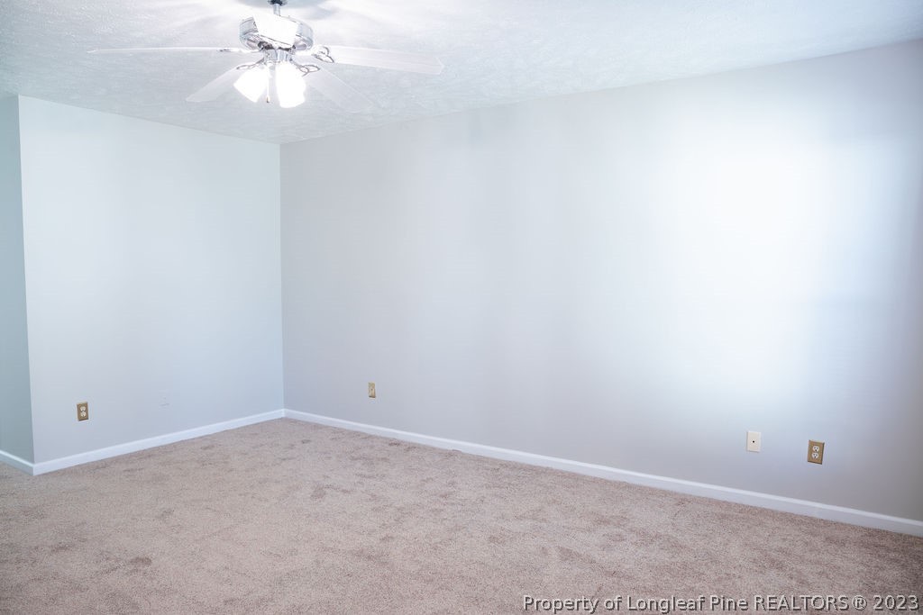 5804 Bibar Road Fayetteville, NC 28304 - Photo 16 of 37 an empty room with a chandelier fan