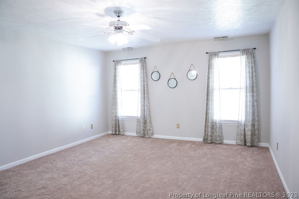 5804 Bibar Road Fayetteville, NC 28304 - Photo 17 of 37 an empty room with windows and fan