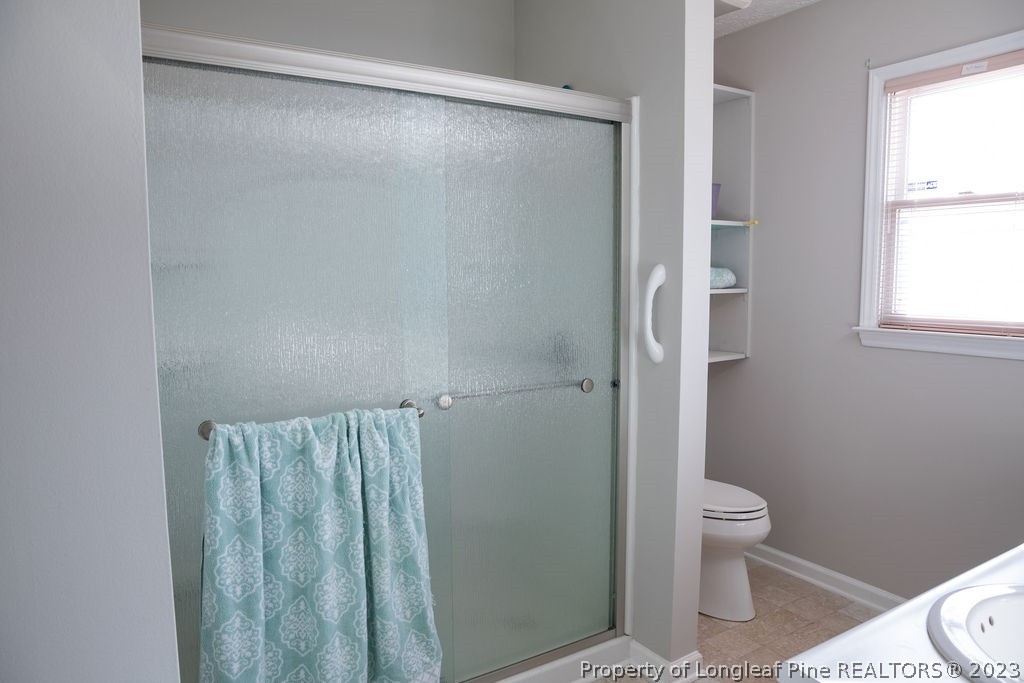 5804 Bibar Road Fayetteville, NC 28304 - Photo 19 of 37 a bathroom with a shower and a toilet