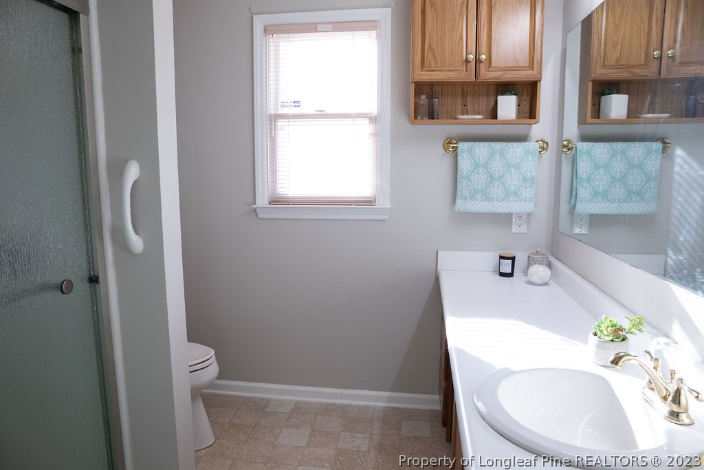 5804 Bibar Road Fayetteville, NC 28304 - Photo 20 of 37 a bathroom with a sink a toilet and tub