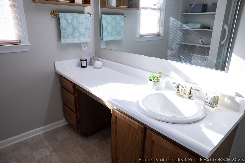 5804 Bibar Road Fayetteville, NC 28304 - Photo 21 of 37 a bathroom with a sink and a mirror