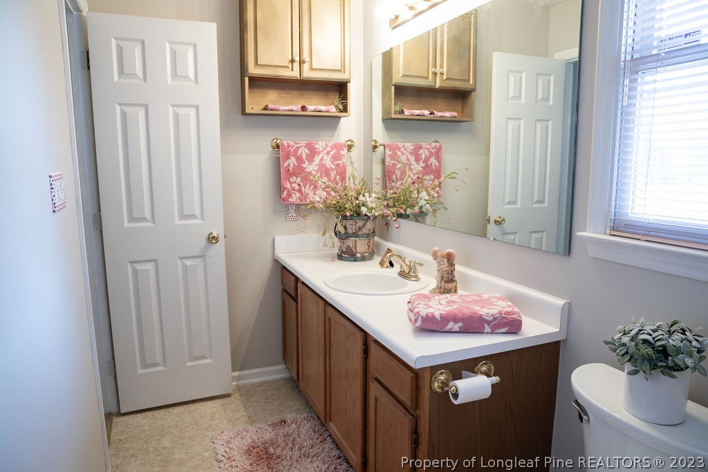 5804 Bibar Road Fayetteville, NC 28304 - Photo 27 of 37 a bathroom with a sink vanity and a mirror