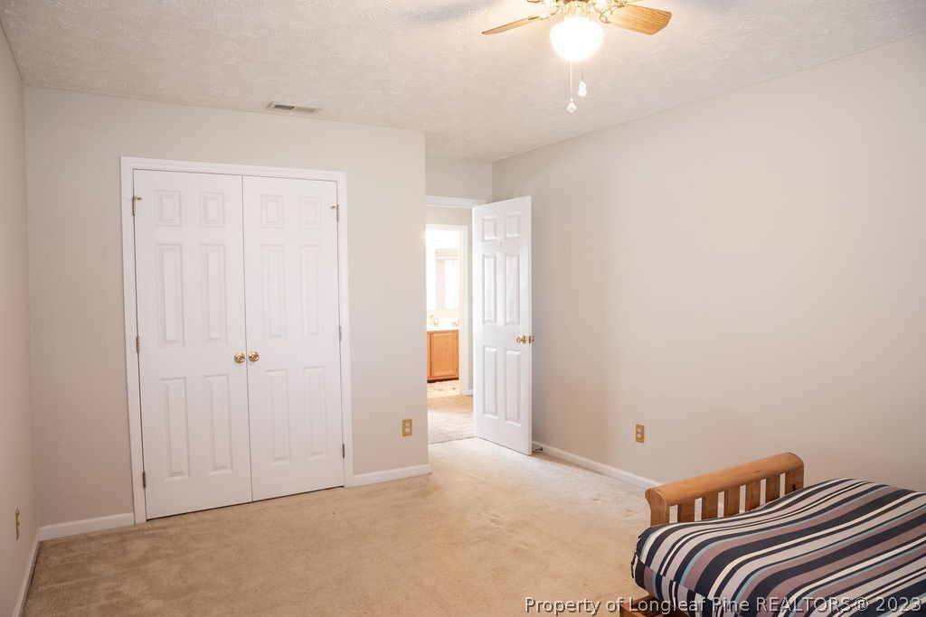 5804 Bibar Road Fayetteville, NC 28304 - Photo 30 of 37 a bedroom with a bed and a chandelier