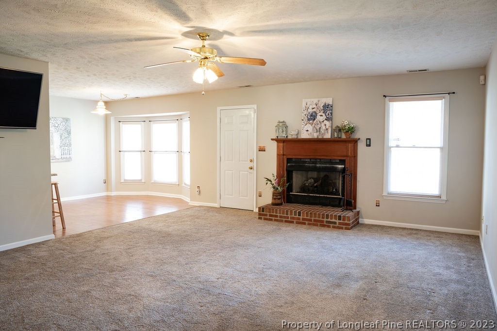 5804 Bibar Road Fayetteville, NC 28304 - Photo 8 of 37 wooden floor fireplace and windows in an empty room