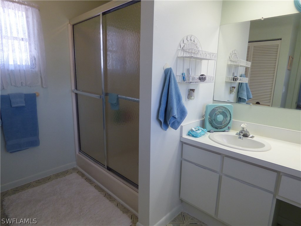 301 Davis Road Lehigh Acres, FL 33936 - Photo 24 of 29 a bathroom with a sink and mirror