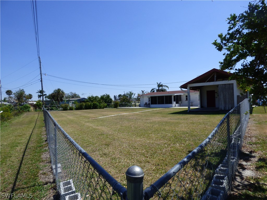 301 Davis Road Lehigh Acres, FL 33936 - Photo 8 of 29 a view of a house with a yard from a balcony