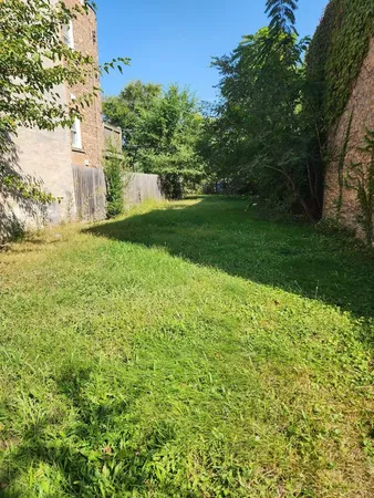 a view of a garden with a building