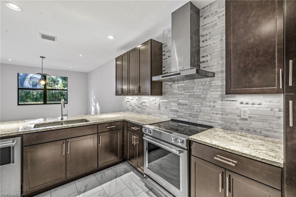 7841 Bristol Circle Naples, FL 34120 - Photo 1 of 28 a kitchen with stainless steel appliances granite countertop a sink stove and cabinets