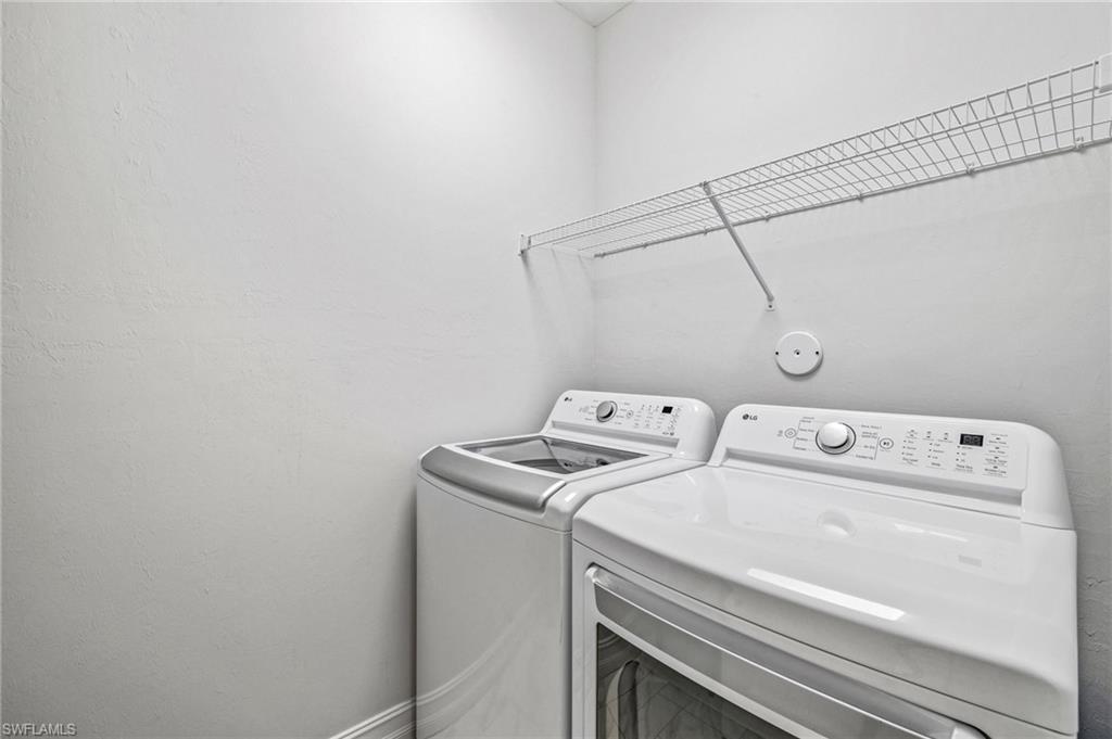 7841 Bristol Circle Naples, FL 34120 - Photo 14 of 28 a utility room with dryer and washer