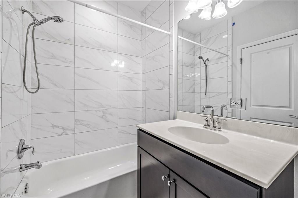 7841 Bristol Circle Naples, FL 34120 - Photo 17 of 28 a bathroom with a sink shower and a bathtub